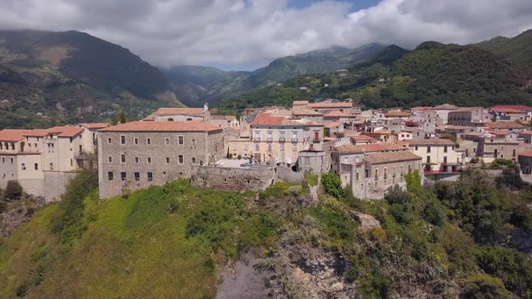 Aerial Medieval City on Hill Overlooking Sea Coast, Village and Mountains, Sunny Day Calabria, Italy alt