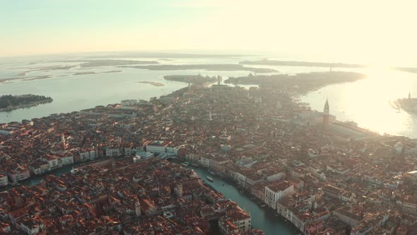 Dolly back aerial drone shot over central and southern Venice City Italy at sunset alt