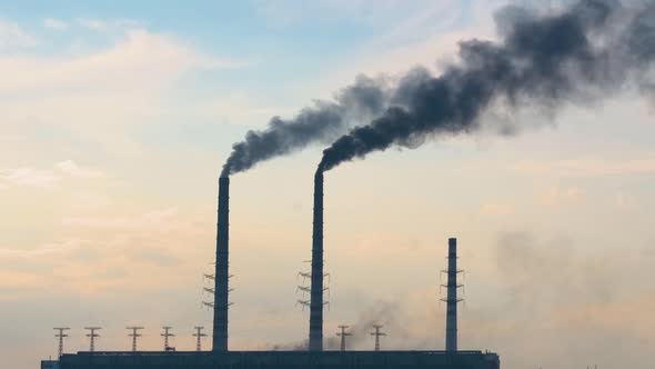 Coal Power Plant High Pipes with Black Smoke Moving Upwards Polluting Atmosphere alt