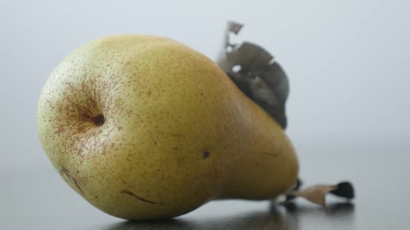 Tasty fruit from genus Pyrus 4K 2160p UltraHD tilting footage - Close-up of yellow organic pear on t alt