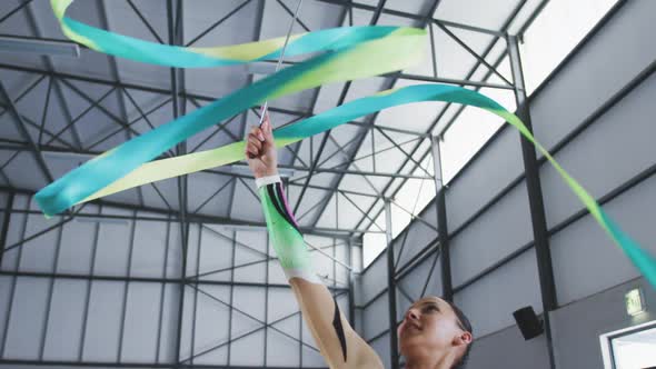 Female gymnast performing at sports hall alt