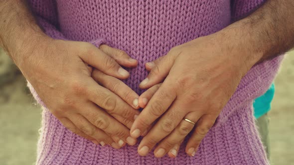 Adult couple in love and tenderness with close up scene of hands having care and touching each other alt