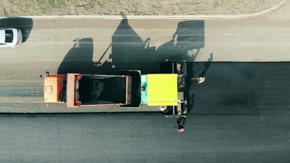 Road Construction Site. Asphalt Motorway Is Getting Manufactured in a Top View alt