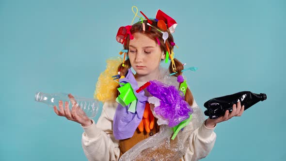 Unhappy young girl holding plastic bottles. 