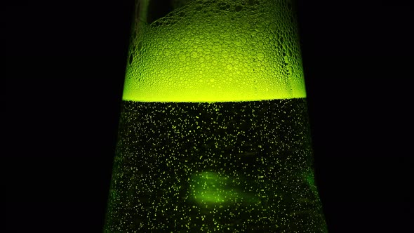A Green Bottle neck with a lot of bubbles