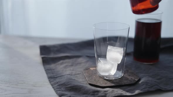 Tracking Dolly Shot of Making Cocktail Aperetivo in Tumbler Glass with Window on Background alt