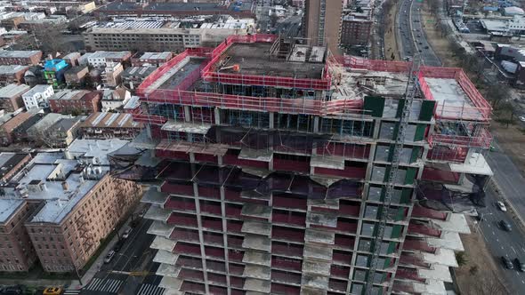 A high angle view above Shore Parkway and a new high-rise construction site in Brooklyn, NY. The dro alt