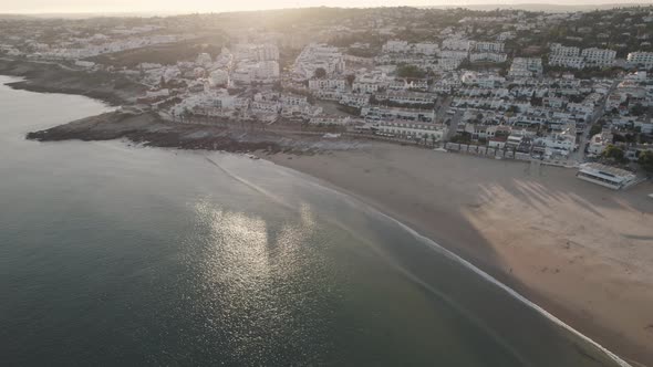 Fly-over deserted Praia da Luz under Sunset lighting, Algarve. Aerial alt
