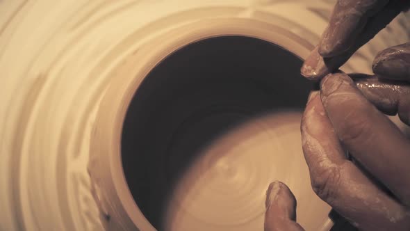 Hands of Woman Working on a Pottery Wheel. Creating a Ceramic Pot alt