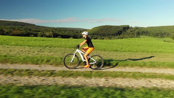 Aerial View Tracking Woman on E-Bike