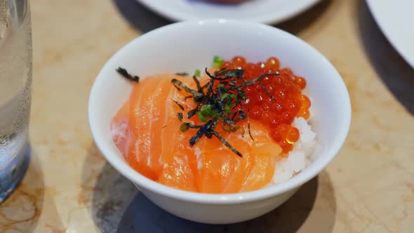 Bowl with Fresh Salmon Red Caviar Grains and Rice alt