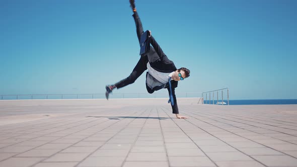 Flexible and cool businessman doing acrobatic tricks outdoor, Stock Footage