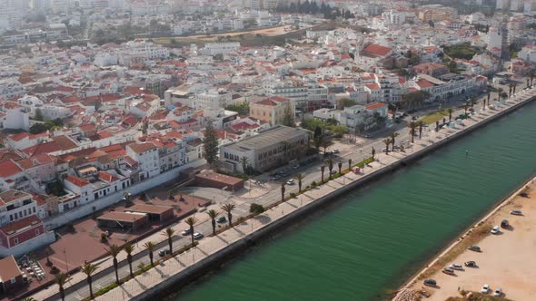 Aerial View of Avenida Dos Descobrimentos Street in Lagos Portugal Drone Flying Sideways Tilting Up alt