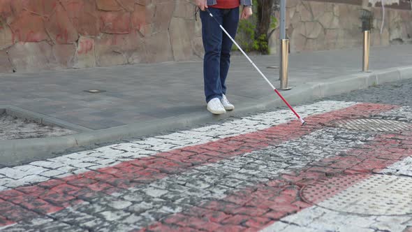Young Blind Man with Using Safety Stick for Walking Alone Outdoors alt