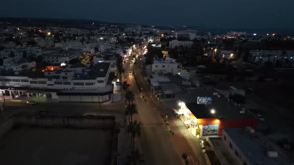 The light of the store at night and the movement of cars. Overnight in Ayia Napa, Cyprus.