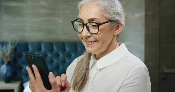 Elderly Woman Texting on Smartphone