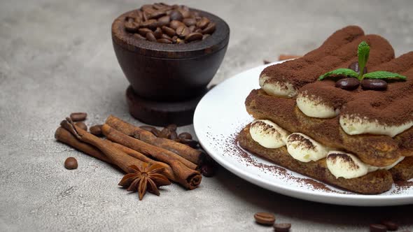 Classic Tiramisu Dessert on Ceramic Plate on Concrete Background alt