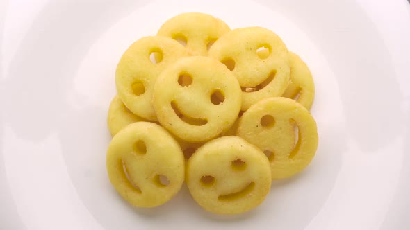 Smiley face french fries on white plate
