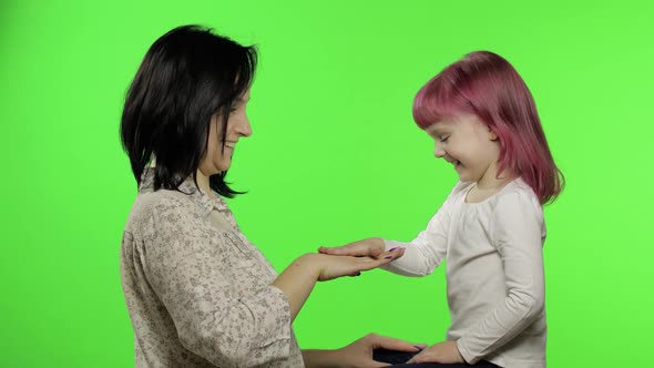 Mother and Little Daughter Playing Rock Paper Scissors. Chroma Key. Leisure Game alt