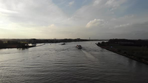 Ship Cruising Across Calm Lake In Oude Maas River Near Zwijndrecht, Netherlands. - Aerial Wide Shot alt