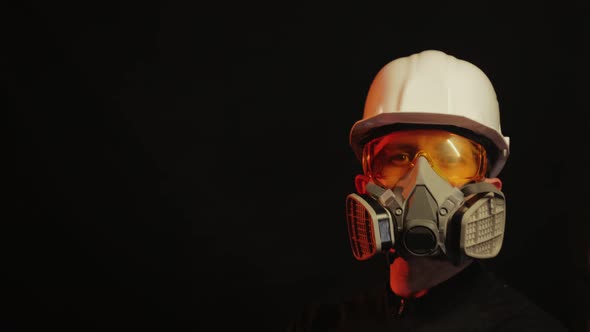 A Man Wearing a Construction Helmet a Dust and Dirt Mask and Safety Glasses