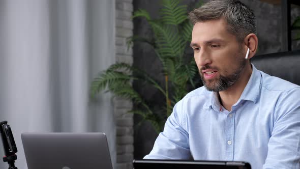 Smiling Man Stock Trader Broker Talks Online Laptop Webcam Video Conference Call alt