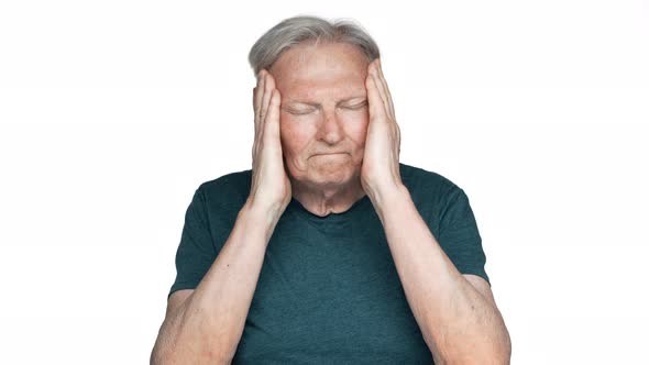 Portrait of Unhealthy Old Aged Man 80s Having Gray Hair in Basic Tshirt Rubbing Temples Because of alt