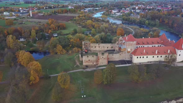 Bauska Medieval Castle Ruins Complex and Park From Above Aerial Shot 4K Video alt