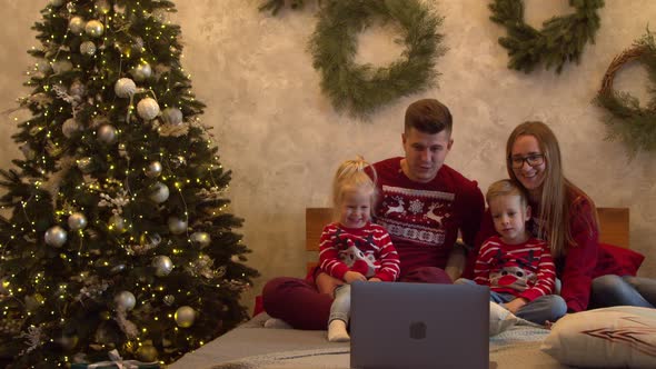 Happy Family Watching Movie Together at Christmas