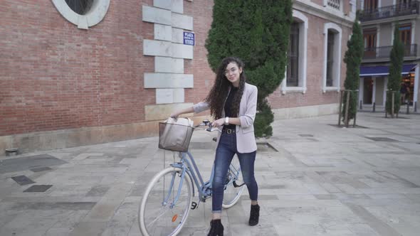 Moroccan Model With A Bicycle Pose And Smiles At The Camera alt