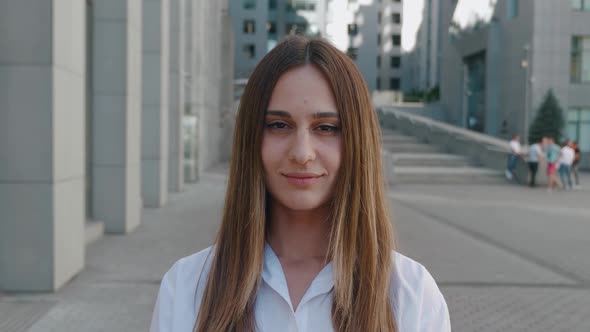 Close Up Portrait of an Attractive Light Brown Woman Opening Her Dark Brown Eyes and Smiling on alt