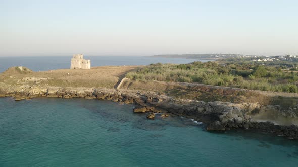 Aerial shot of coastline with a small castle on the beach, Puglia. Italy