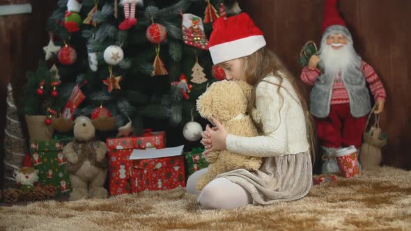 Girl Playing with a Teddy Bear alt