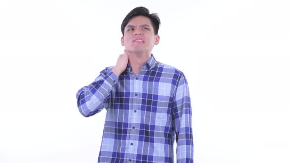 Stressed Young Asian Hipster Man Having Neck Pain alt