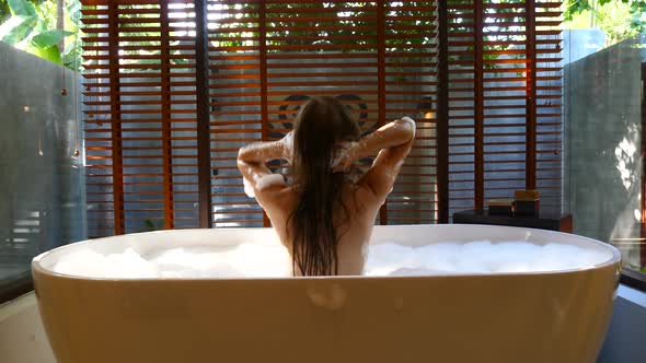 Young Naked Woman Bathing with Foam Sexy Female Back in Soap Bubbles Bathtub alt