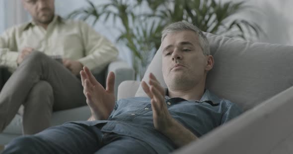 Therapist talking to his patient during a session