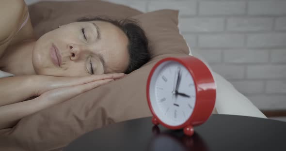 Woman laying in bed at night. alt