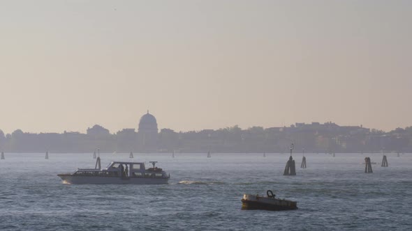 A Powerboat Crossing the Water Against the Beautiful Evening Venice View alt