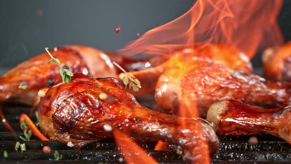 Super Slow Motion Shot of Seasoning Falling on Fresh Grilled Chicken Legs at 1000 Fps alt