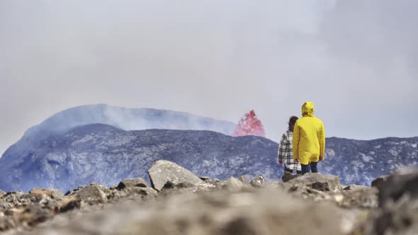 Awesome Drone Shot of an Erupting Volcanowith Tourists Admiring the View alt