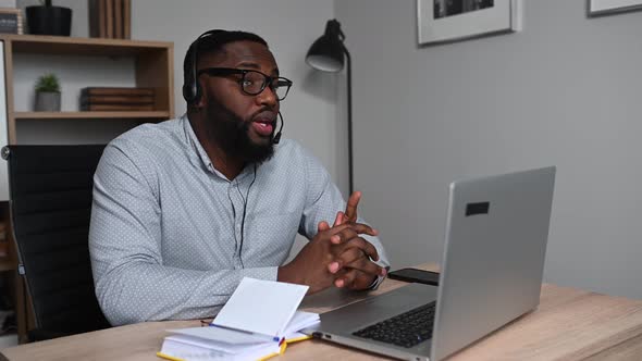 An African Guy Is Using Headset for Work alt