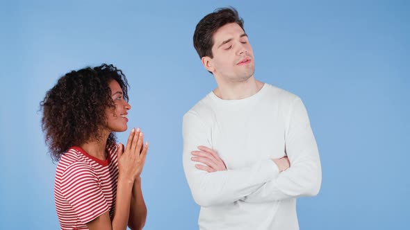 Cute African Young Woman Begging Her Boyfriend or Husband About Something Over Blue Background alt