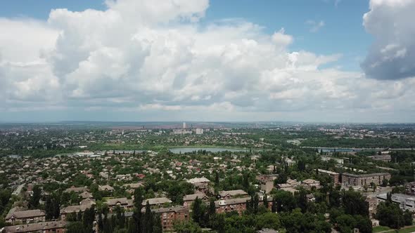 gAn industrial city on a sunny summer day after the rain. A blue sky with hue blocks loomed alt