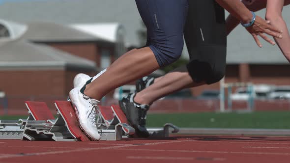 Track runners leave starting blocks in super slow motion, shot on Phantom Flex 4K