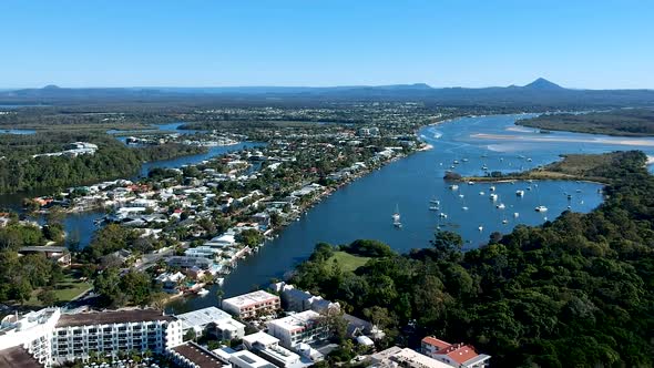 Aerial panning shot of Noosa town and boats harboured, Noosa Heads ...