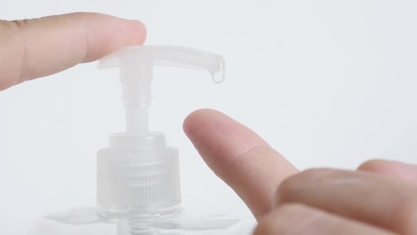 Sanitizer gel in plastic bottle taken on finger slow-mo footage alt