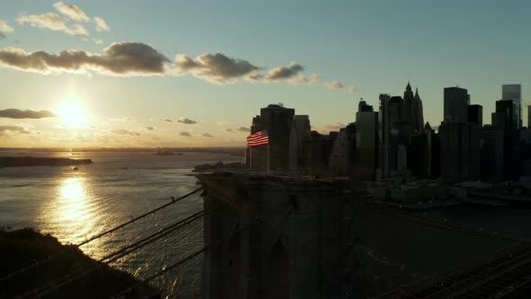 Orbit Shot Around American Flag Waving in Wind on Top of Brooklyn Bridge alt