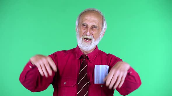 Portrait of Happy Old Aged Man 70s Clapping His Hands, Isolated Over Green Background. alt