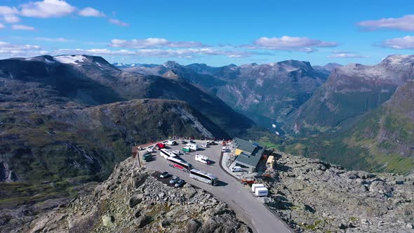 Flying over Geiranger Viewpoint surrounded by mountains and curvy roads on the valley alt