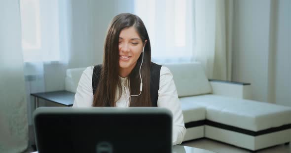 Joyful Lady with Headphones Talks To Friend on Video Call alt